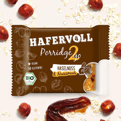 Hafervoll Porridge2go Unt de alune și nuci, 13 batoane x 55g - Vegan, Organic, Fără gluten, Gustare fără zahăr adăugat, cu ovăz, curmale și bomboane de quinoa
