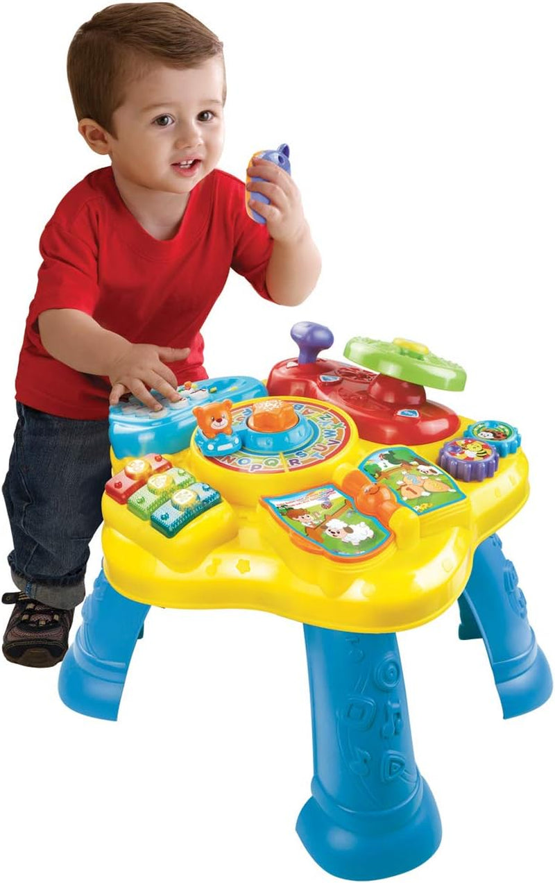 VTech Baby Adventure Play Table - Table de jeu colorée pour bébés avec 6 terrains de jeu et éléments interactifs & Baby My First Song Book Livre coloré de 6 pages et éléments mobiles pour jouer Bebe Toys Naty Shop
