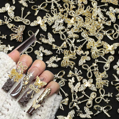 50pcs 3D Gold Bow Nail Charms Butterfly Nail Art Charms Legierung Bogen Nagel Charms Nägel Zubehör Schleife Nagelschmuck Metall Schleifen Schmetterling Nageldesign Nagelanhänger Nailart Strasssteine