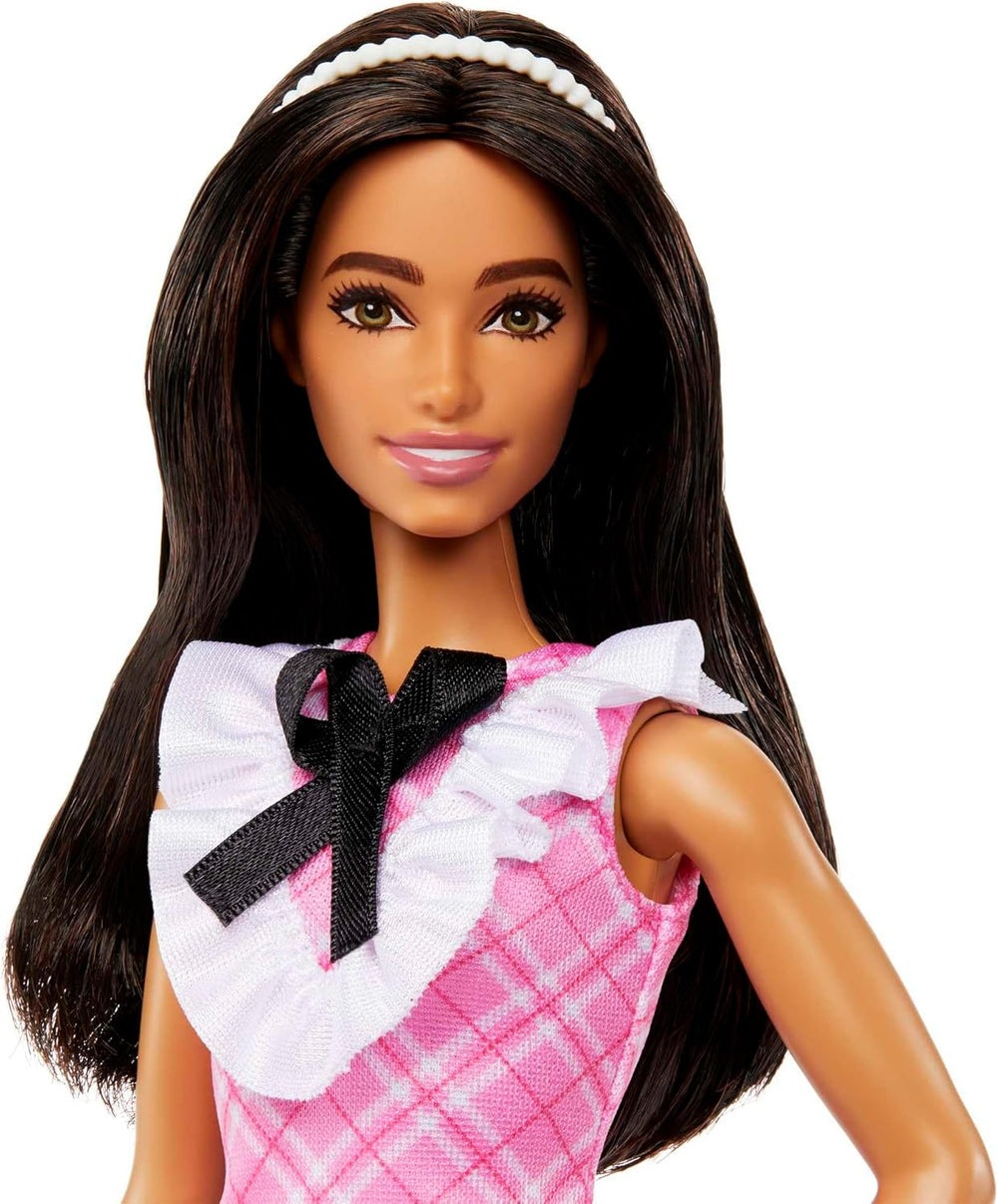 Poupée Barbie Fashionistas avec cheveux noirs et bandeau de perles portant une robe à carreaux rose avec nœud noir et col à volants pour 3 ans et plus HJT06