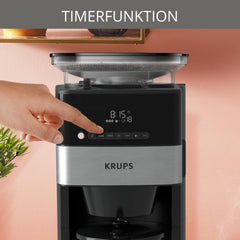 Machine à expresso Krups KM8328 Grind avec broyeur | Minuterie 24 heures | Contenant à céréales 180 g | Capacité 1,25 l pour jusqu'à 15 tasses de café | Fonction de mise hors tension automatique | 3 réglages de mouture | Noir