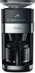 Machine à expresso Krups KM8328 Grind avec broyeur | Minuterie 24 heures | Contenant à céréales 180 g | Capacité 1,25 l pour jusqu'à 15 tasses de café | Fonction de mise hors tension automatique | 3 réglages de mouture | Noir